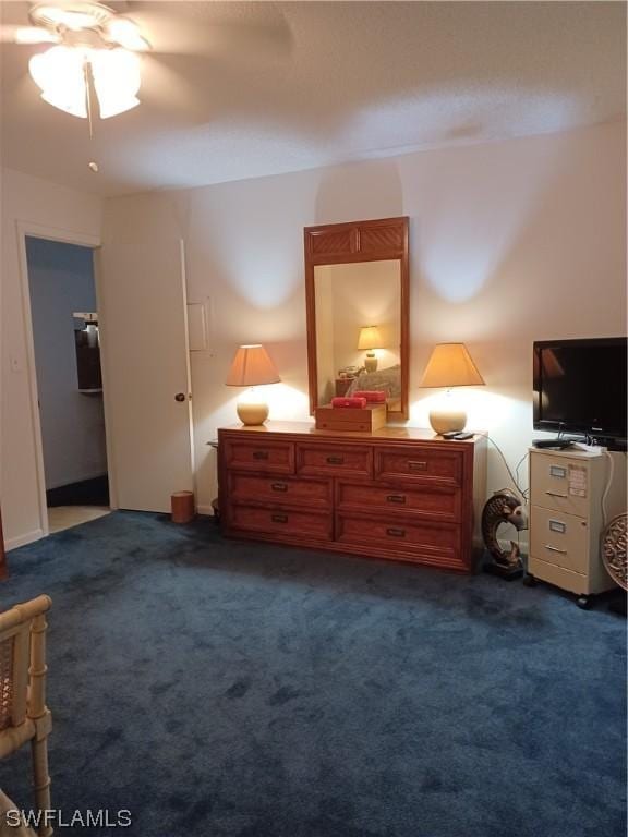 bedroom with ceiling fan and dark carpet