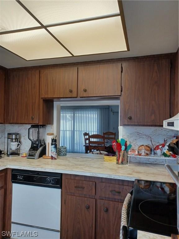 kitchen with dishwasher, decorative backsplash, and range