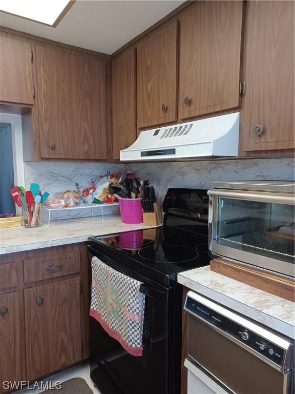 kitchen with dishwashing machine, black range with electric cooktop, and backsplash