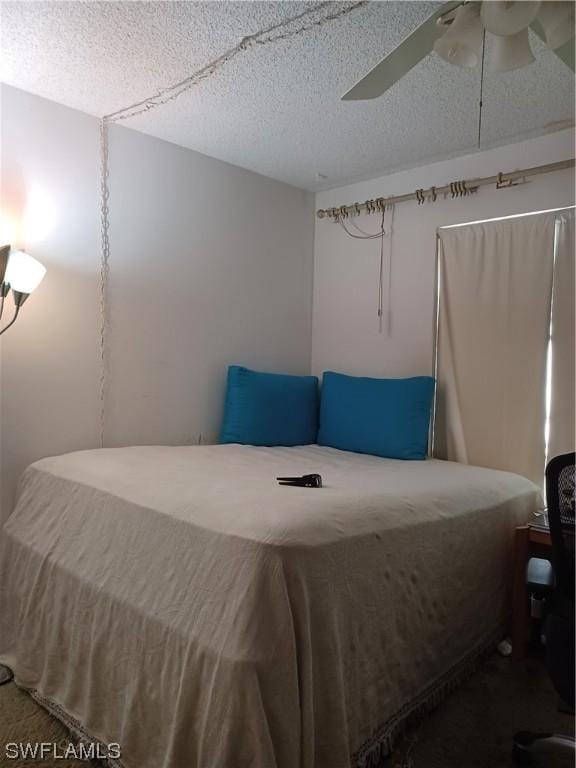 bedroom featuring a textured ceiling and ceiling fan