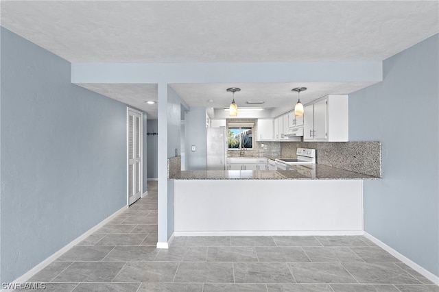 kitchen featuring stainless steel refrigerator, white cabinetry, stone counters, white electric stove, and kitchen peninsula