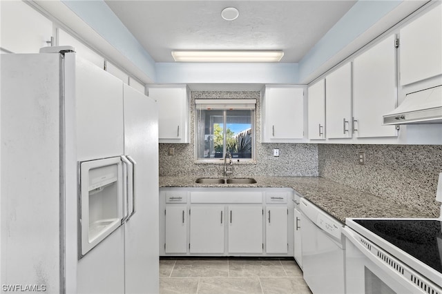 kitchen featuring backsplash, white appliances, sink, stone counters, and white cabinetry