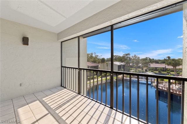 unfurnished sunroom with a water view