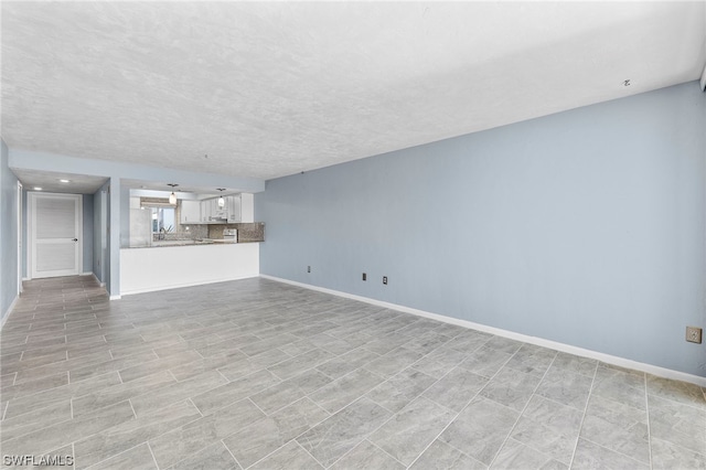 unfurnished living room featuring a textured ceiling