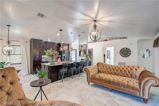 living room with vaulted ceiling and a notable chandelier