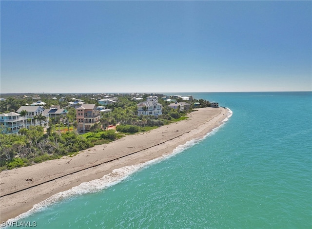 birds eye view of property featuring a beach view and a water view