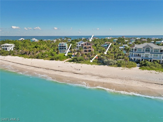 drone / aerial view with a beach view and a water view