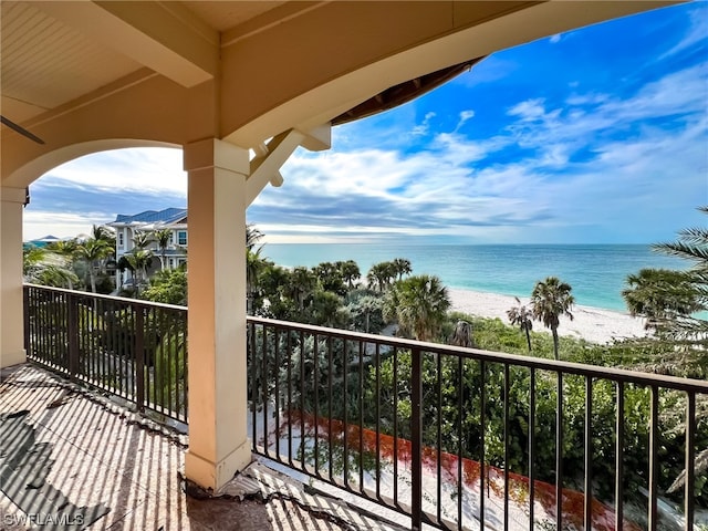 balcony with a view of the beach and a water view