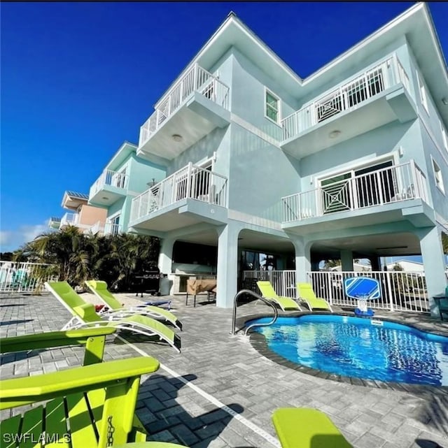 community pool with a patio and fence