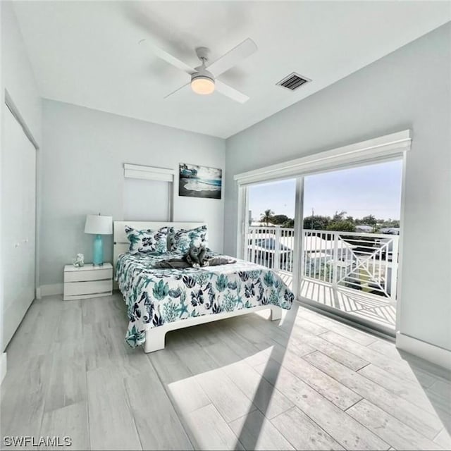 bedroom with baseboards, visible vents, ceiling fan, wood finished floors, and access to outside