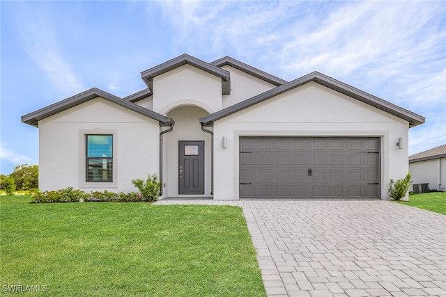 single story home featuring a front yard, decorative driveway, a garage, and stucco siding