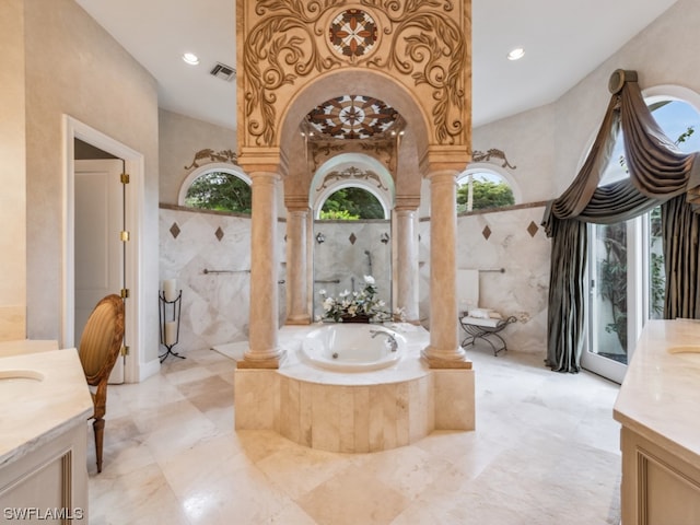 bathroom featuring vanity, decorative columns, vaulted ceiling, and tile walls