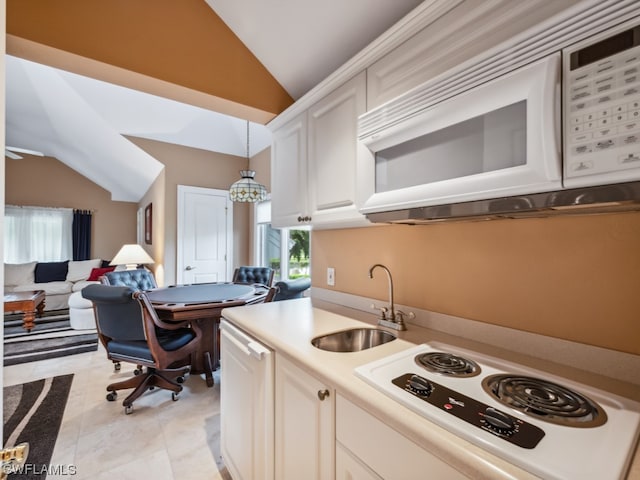 kitchen featuring vaulted ceiling, sink, pendant lighting, and white appliances