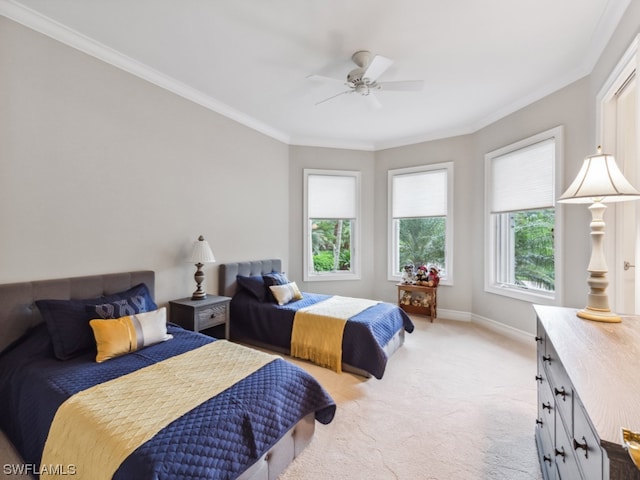 carpeted bedroom with multiple windows, ceiling fan, and ornamental molding