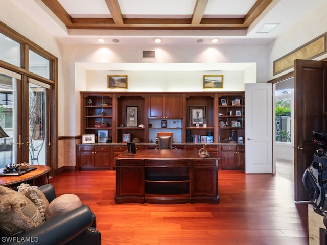 office featuring beamed ceiling, hardwood / wood-style flooring, and a healthy amount of sunlight