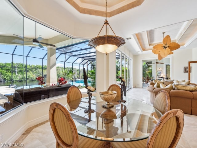 dining room with a raised ceiling and ceiling fan