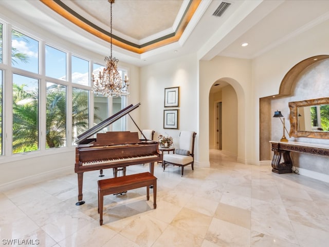 misc room featuring crown molding, a wealth of natural light, and a notable chandelier