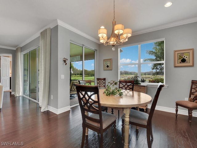 dining space featuring crown molding, dark wood-type flooring, and a chandelier