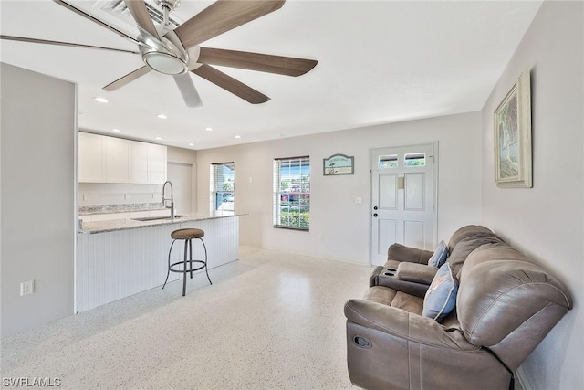 living room with sink and ceiling fan