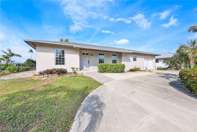 ranch-style house with a garage and a front yard