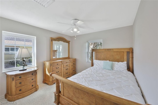 bedroom with multiple windows and ceiling fan