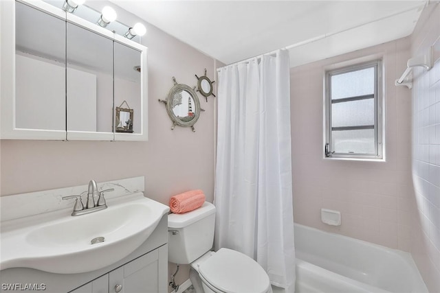 full bathroom featuring vanity, shower / bath combination with curtain, and toilet