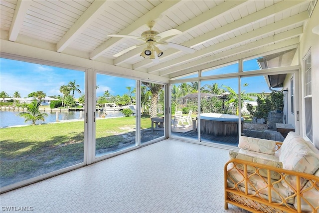 unfurnished sunroom with a water view, vaulted ceiling with beams, and ceiling fan