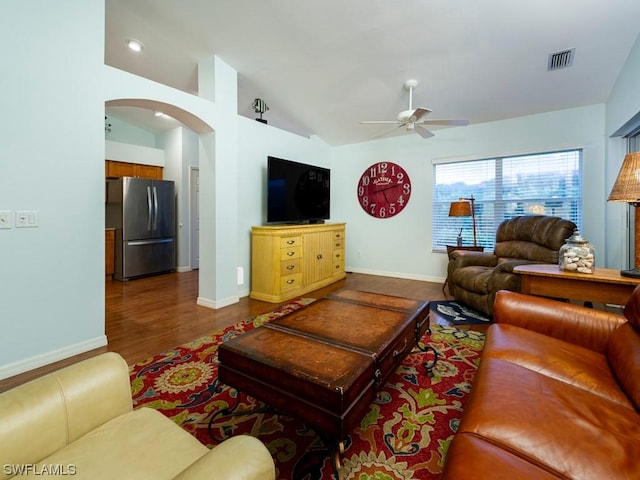 living room with vaulted ceiling, dark hardwood / wood-style floors, and ceiling fan