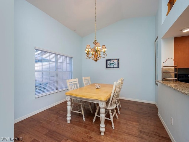 dining space featuring dark wood-type flooring, an inviting chandelier, and high vaulted ceiling