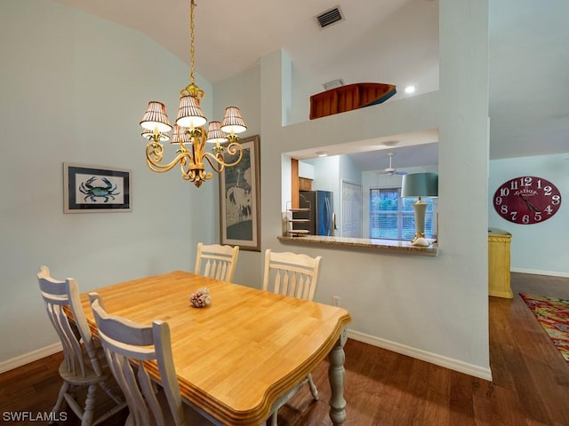 dining space featuring an inviting chandelier, high vaulted ceiling, and dark hardwood / wood-style floors