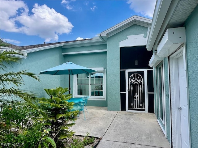 property entrance featuring a patio area