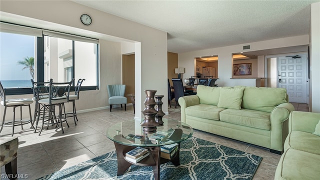 6672 Estero Blvd Unit A409, Fort Myers Beach, FL 33931 - tiled living room with a water view and a textured ceiling