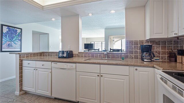 6672 Estero Blvd Unit A409, Fort Myers Beach, FL 33931 - kitchen featuring white dishwasher, white cabinets, sink, decorative backsplash, and light tile patterned floors
