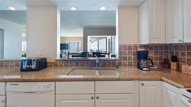6672 Estero Blvd Unit A409, Fort Myers Beach, FL 33931 - kitchen with dishwasher, sink, light stone countertops, a textured ceiling, and white cabinetry