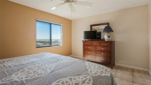 6672 Estero Blvd Unit A409, Fort Myers Beach, FL 33931 - bedroom with ceiling fan and a textured ceiling