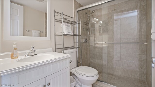6672 Estero Blvd Unit A409, Fort Myers Beach, FL 33931 - bathroom with vanity, toilet, and an enclosed shower
