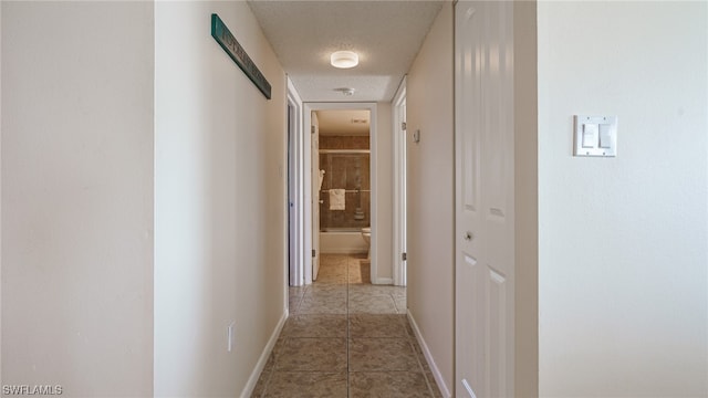 6672 Estero Blvd Unit A409, Fort Myers Beach, FL 33931 - corridor featuring light tile patterned flooring and a textured ceiling