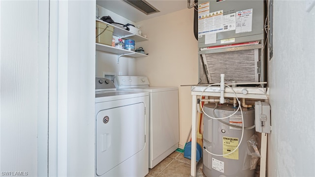 6672 Estero Blvd Unit A409, Fort Myers Beach, FL 33931 - laundry area with heating unit, electric water heater, washer and clothes dryer, and light tile patterned floors