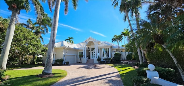 view of front of house featuring a front yard, french doors, and a garage