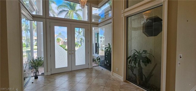 foyer entrance with light tile patterned floors and french doors