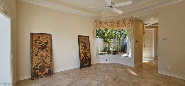 spare room featuring ceiling fan and ornamental molding