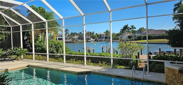 view of swimming pool featuring a water view, glass enclosure, and a patio