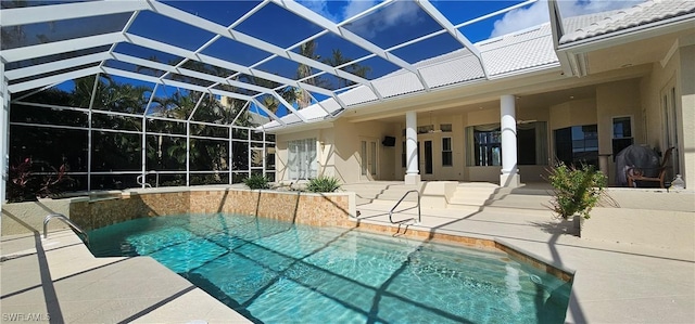 view of pool with ceiling fan, a lanai, and a patio area