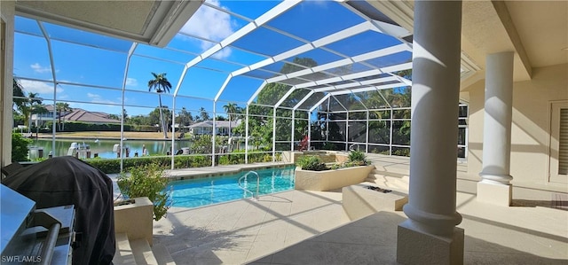 view of pool featuring a patio area, a lanai, grilling area, and a water view