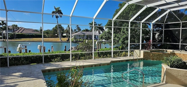 view of swimming pool featuring a hot tub, a patio area, a lanai, and a water view