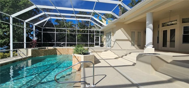 view of swimming pool featuring a patio, french doors, and a lanai