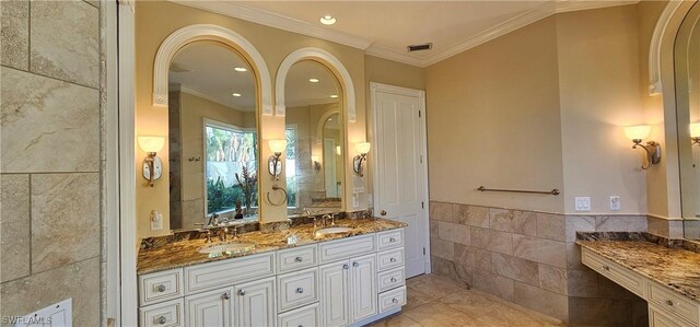 bathroom featuring crown molding, tile walls, and vanity