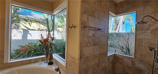 bathroom featuring independent shower and bath