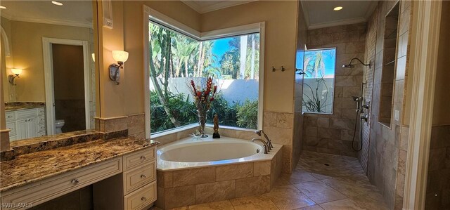 full bathroom featuring toilet, vanity, crown molding, and independent shower and bath