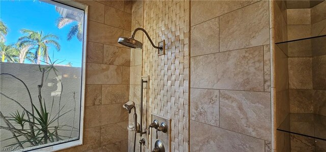 interior details featuring a tile shower